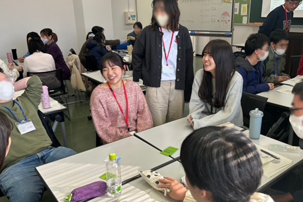 写真:テーブルを囲んで話し合う受講生とスタッフ